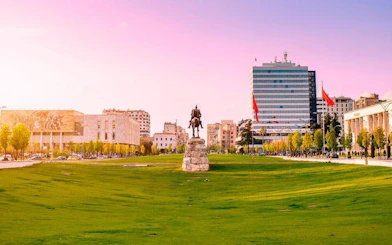 Skanderbeg Square in Tirana with statue and surrounding buildings.