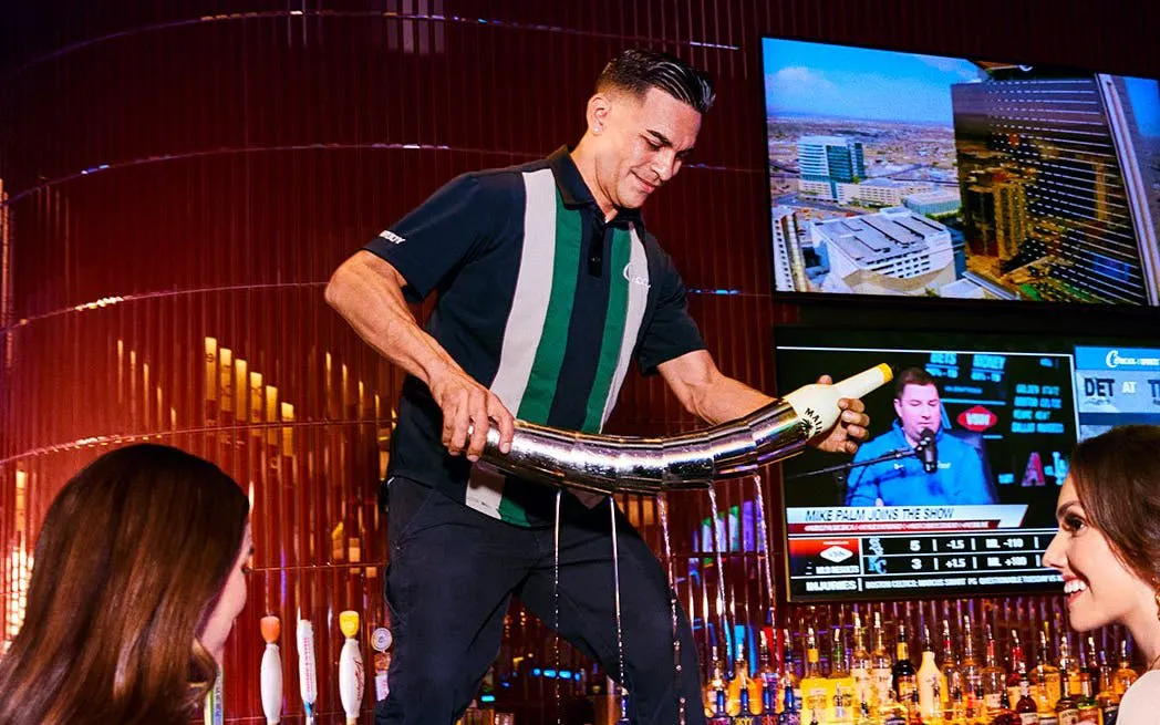 Bartender pouring drink at a Downtown Las Vegas bar during self-guided crawl.