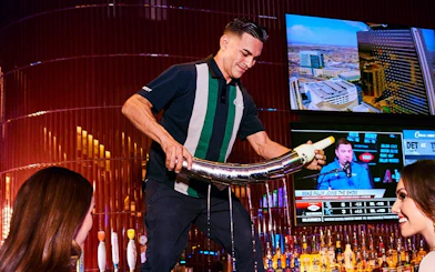 Bartender pouring drink at a Downtown Las Vegas bar during self-guided crawl.