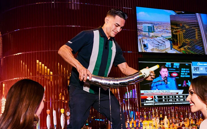 Bartender pouring drink at a Downtown Las Vegas bar during self-guided crawl.