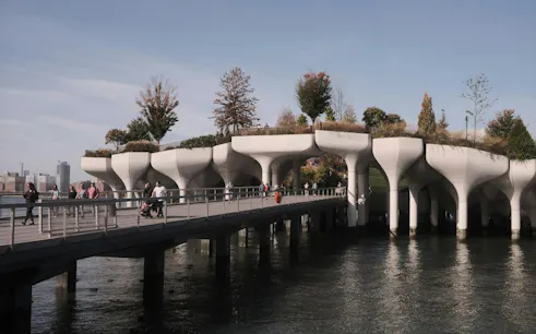 Little Island park on the Hudson River with visitors walking along the pier, New York.