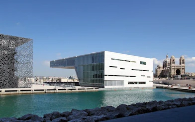 Modern architecture and historic cathedral by the sea in Marseille, France.