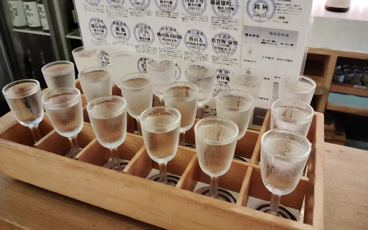 Sake glasses arranged for tasting at Fushimi Sake Brewery in Kyoto.