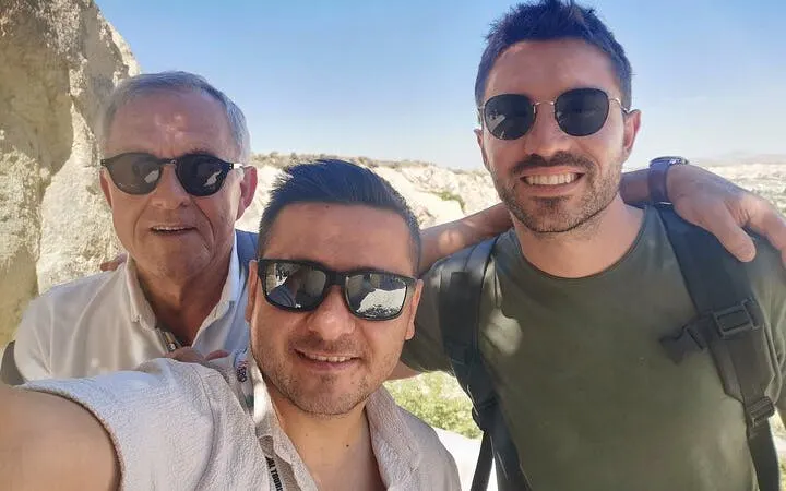 Tourists enjoying Cappadocia Red Tour with scenic backdrop.
