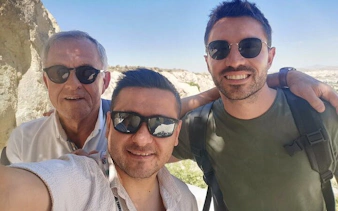 Tourists enjoying Cappadocia Red Tour with scenic backdrop.
