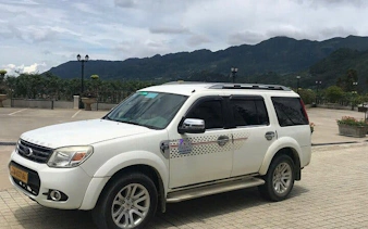 Private car parked with mountain view, Sapa to Ha Noi transfer.