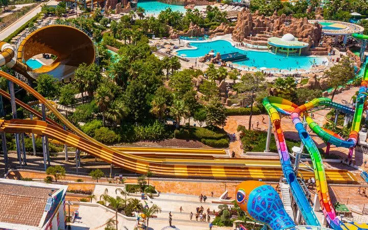 The Land of Legends Theme Park water slides and pools with lush surroundings.