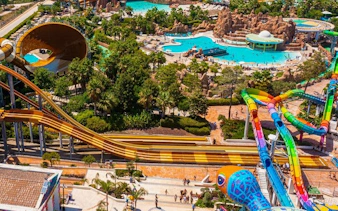 The Land of Legends Theme Park water slides and pools with lush surroundings.