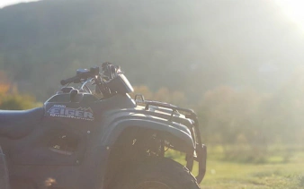 Quad bike on grassy terrain during Krakow off-road tour.