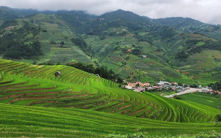 Terraced rice fields in Mu Cang Chai with ethnic village and lush landscapes.