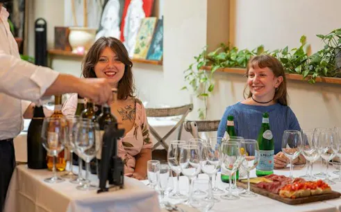 Sommelier presenting wines to guests during tasting in Florence.
