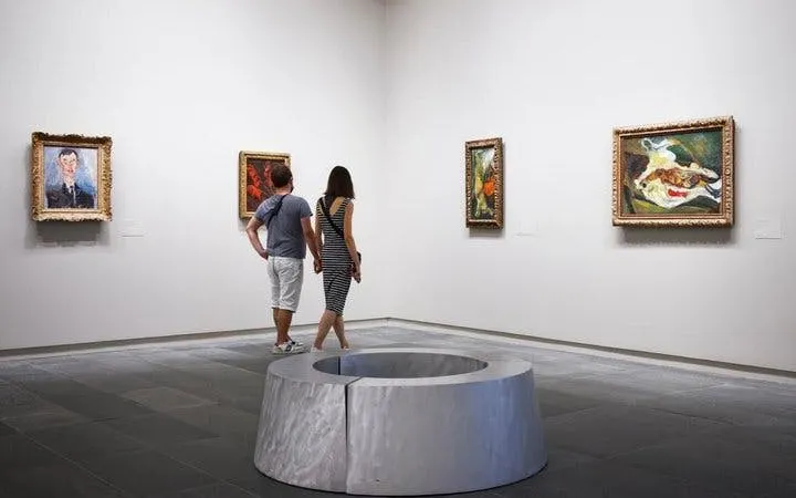 Visitors viewing paintings at Musée de l'Orangerie, Paris.