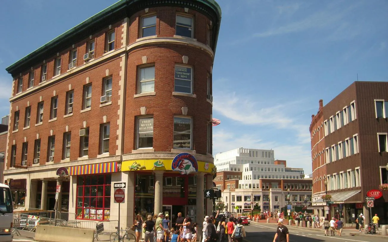 Harvard Square street view with historic buildings and pedestrians in Boston.