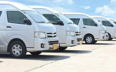 Private vans lined up for Chiang Mai Airport transfer to city hotels.