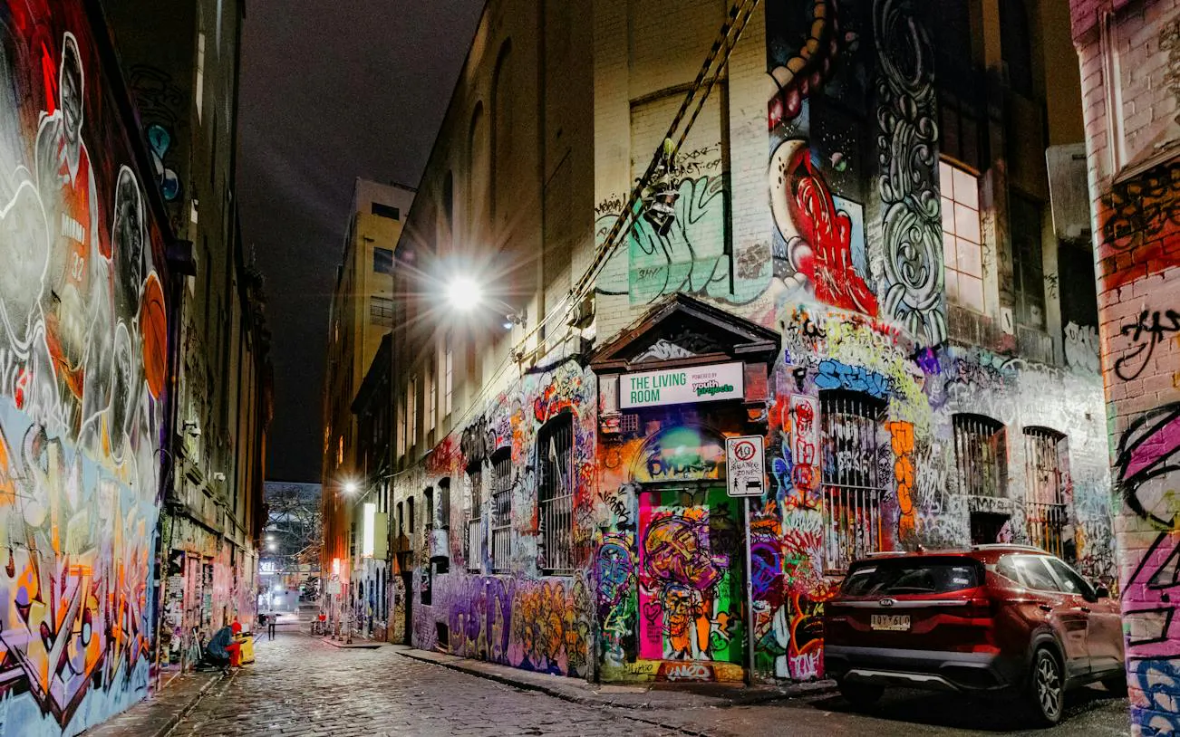 Graffiti-covered laneway in Melbourne at night, part of self-guided audio walking tour.