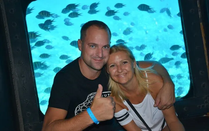 Couple enjoying underwater views on semi-submarine tour in Sharm El Sheikh.