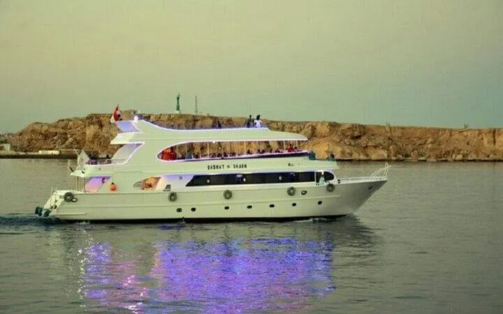 Boat with party lights on water near Sharm El Sheikh coast.