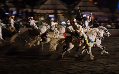 Riders in traditional attire perform at Chez Ali Folklore Show, Marrakesh.