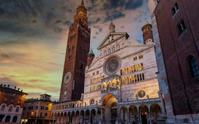 Cremona Cathedral and Torrazzo tower at sunset, part of self-guided audio walking tour.