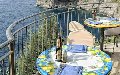 Seaside dining with lemon-themed tables overlooking the Amalfi Coast.