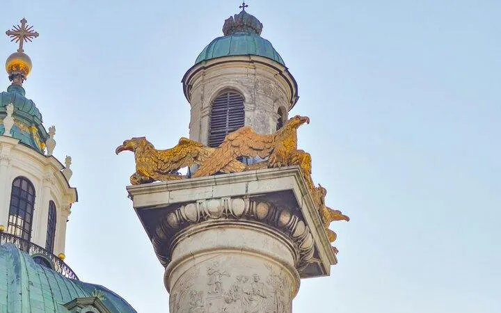 Karlskirche column with golden eagles, part of the Espionage in Vienna self-guided city exploration game.