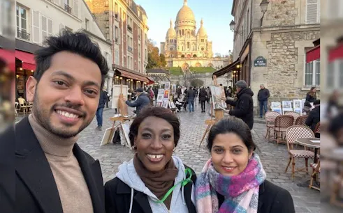 Montmartre street with Sacré-Cœur Basilica in background during guided walking tour.