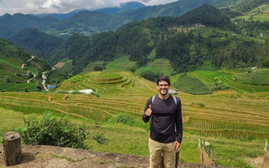 Mu Cang Chai rice terraces with a visitor enjoying the view during a trekking tour.