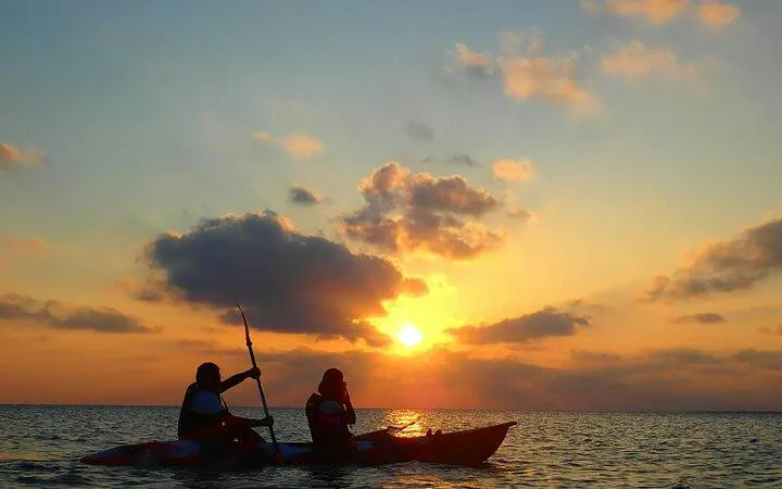 Canoeists paddling during sunset on Ishigaki Island, Okinawa.