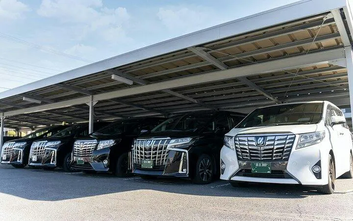 Luxury vehicles for Nagoya airport transfer service under a covered parking area.