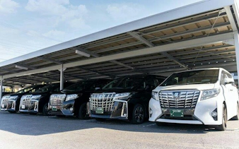Luxury vehicles for Nagoya airport transfer service under a covered parking area.