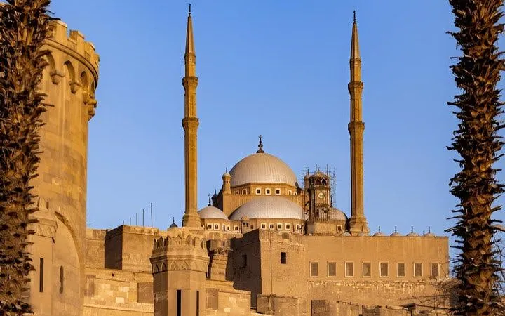 Citadel of Saladin in Cairo with minarets and domes under a clear sky.