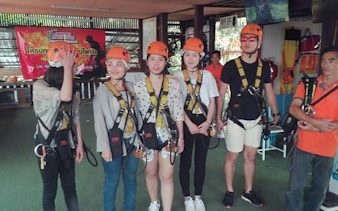 Participants in harnesses preparing for Chiang Mai jungle zipline experience.