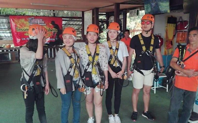 Participants in harnesses preparing for Chiang Mai jungle zipline experience.