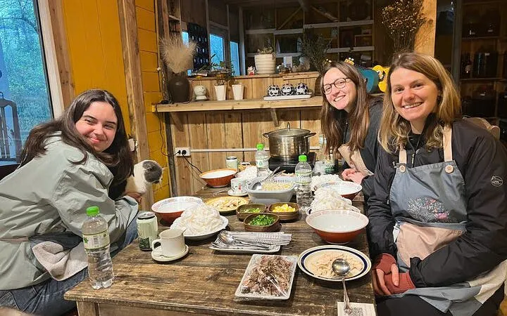 Cooking class participants enjoying a Pho noodle soup meal with a local chef.