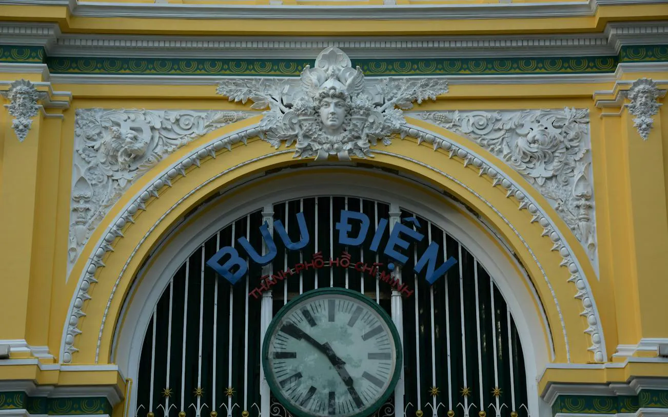 Facade of the Central Post Office in Ho Chi Minh City's French Quarter with ornate details.