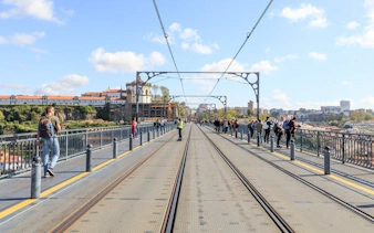 Pedestrians on Dom Luís I Bridge during Porto self-guided audio walking tour.
