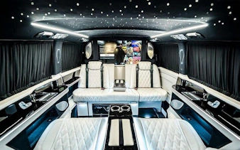 Luxurious interior of a private transfer vehicle at Antalya Airport, featuring plush seating and ambient lighting.