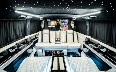 Luxurious interior of a private transfer vehicle at Antalya Airport, featuring plush seating and ambient lighting.