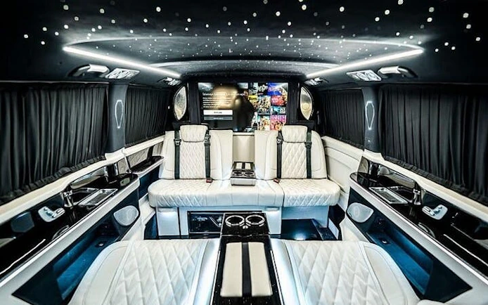 Luxurious interior of a private transfer vehicle at Antalya Airport, featuring plush seating and ambient lighting.