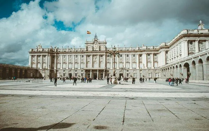 Royal Palace of Madrid with visitors in the courtyard, part of Madrid Old Town tour.