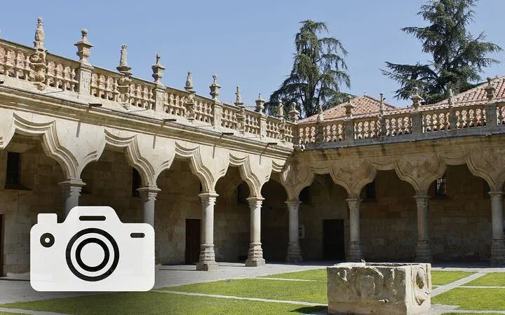 Courtyard of the University of Salamanca with ornate arches and stone carvings.