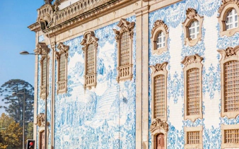 Azulejo-tiled facade of a historic building in Porto, Portugal, featured in a self-guided walking tour.