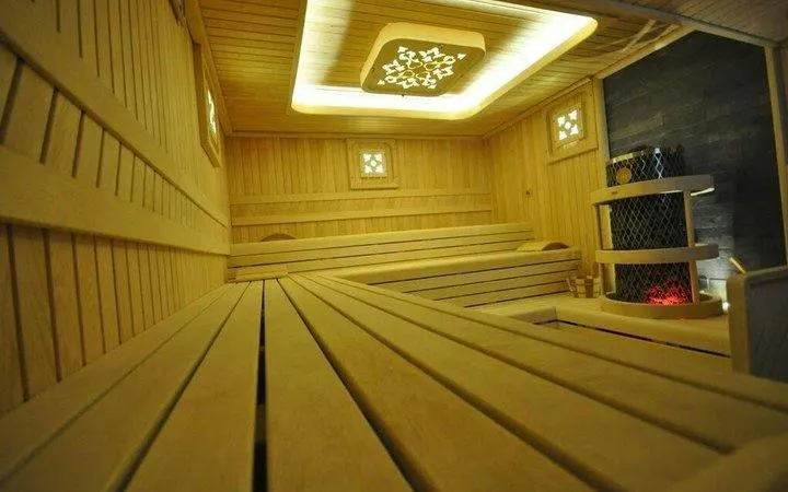 Turkish bath sauna room with wooden benches and decorative ceiling in Istanbul.