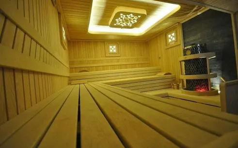 Turkish bath sauna room with wooden benches and decorative ceiling in Istanbul.