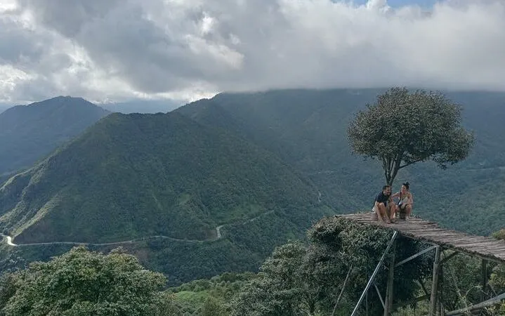 Sapa mountain view with tourists on a wooden platform, part of motorbike tour to waterfall and Pusamcap Cave.