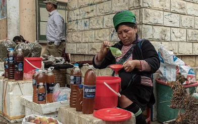 Local vendor preparing traditional drinks at a Sapa market during a guided food tour.
