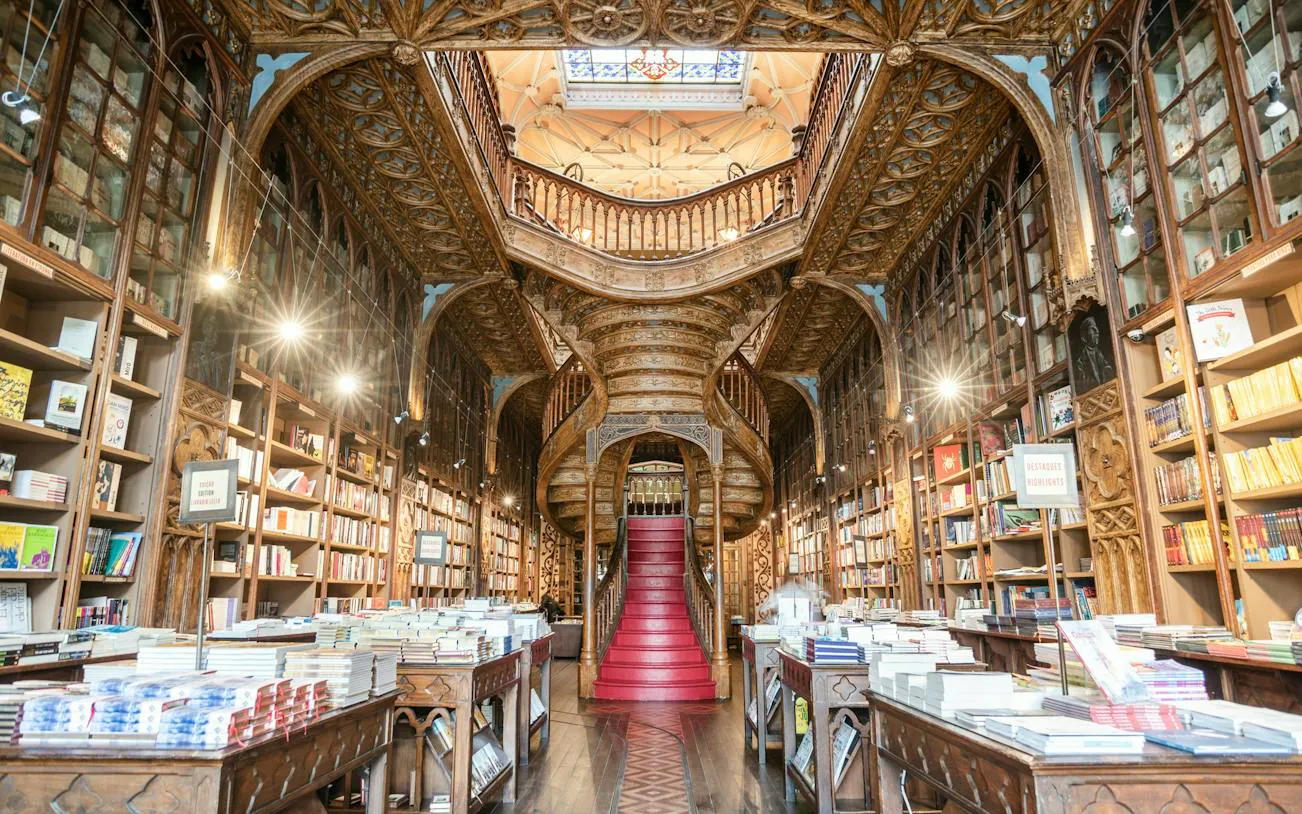Historic bookstore interior with ornate staircase, Porto Historic Center, self-guided audio walking tour.