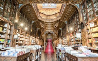 Historic bookstore interior with ornate staircase, Porto Historic Center, self-guided audio walking tour.