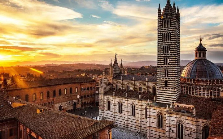 Siena Cathedral at sunset during self-guided walking tour on mobile app.