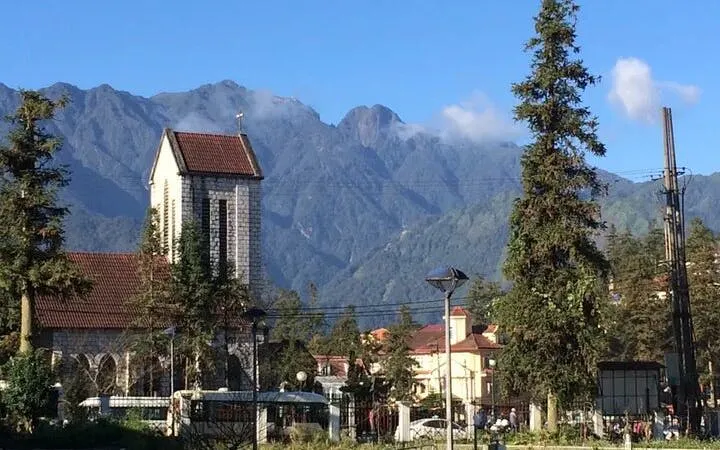 Stone Church in Sapa with mountain backdrop on cultural tour.